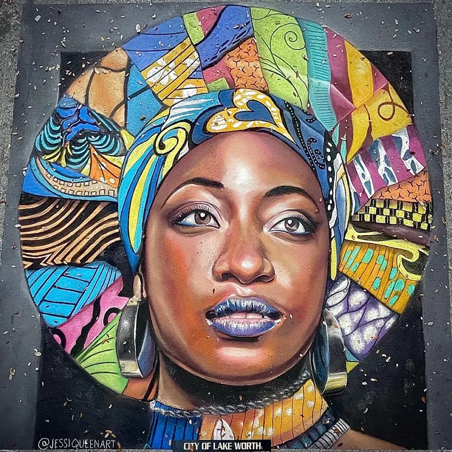 Chalk portrait of a Black woman framed by a bright patterned head wrap and mosaic halo