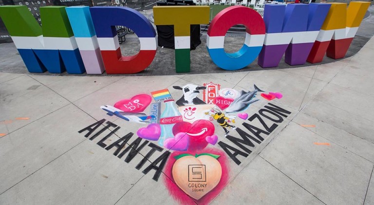 Finished Valentine’s chalk mural of hearts and Atlanta landmarks in front of the colorful Midtown letters