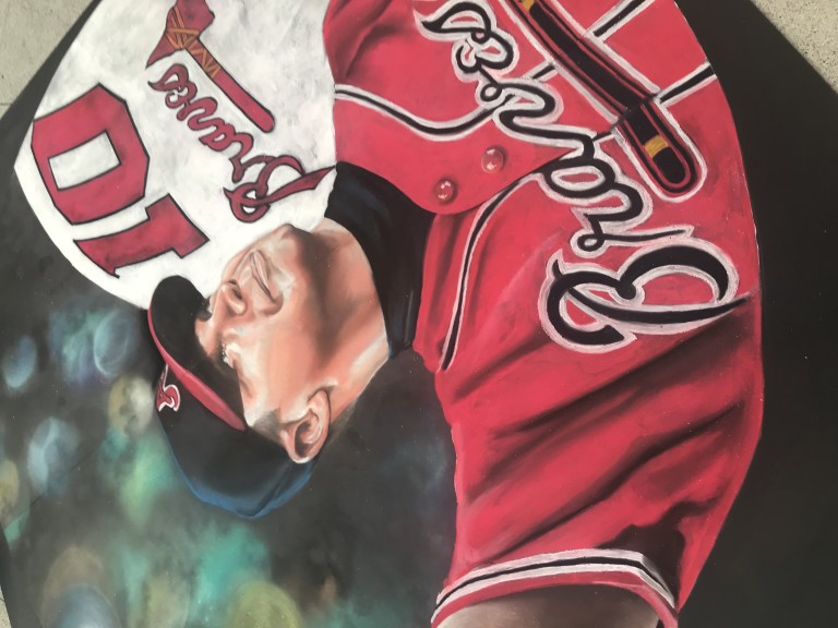 Chalk portrait of Chipper Jones in a red Braves jersey and batting helmet, drawn on the pavement