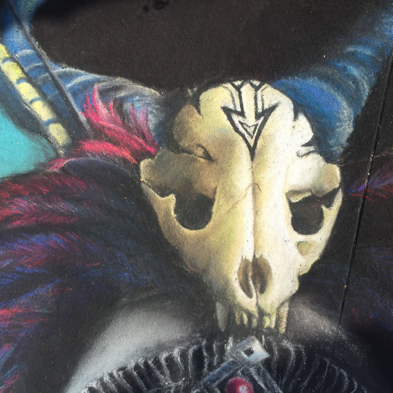 Close-up of the chalk animal skull ornament on top of the feathered headdress