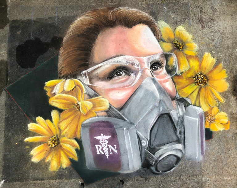 Chalk portrait of a nurse in safety goggles and a respirator, framed by yellow flowers
