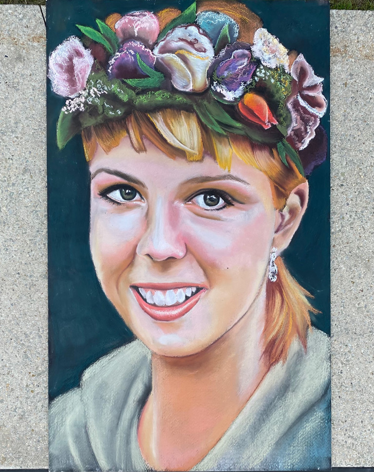 Chalk memorial portrait of a smiling young woman wearing a crown of flowers