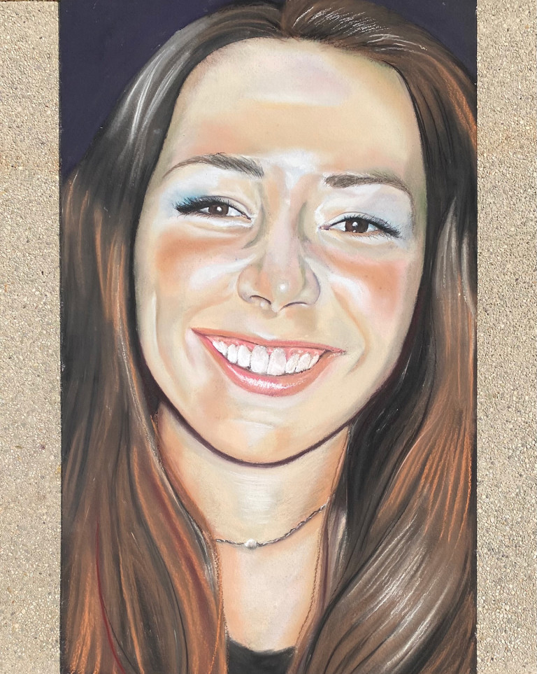 Chalk memorial portrait of a smiling woman with long auburn hair
