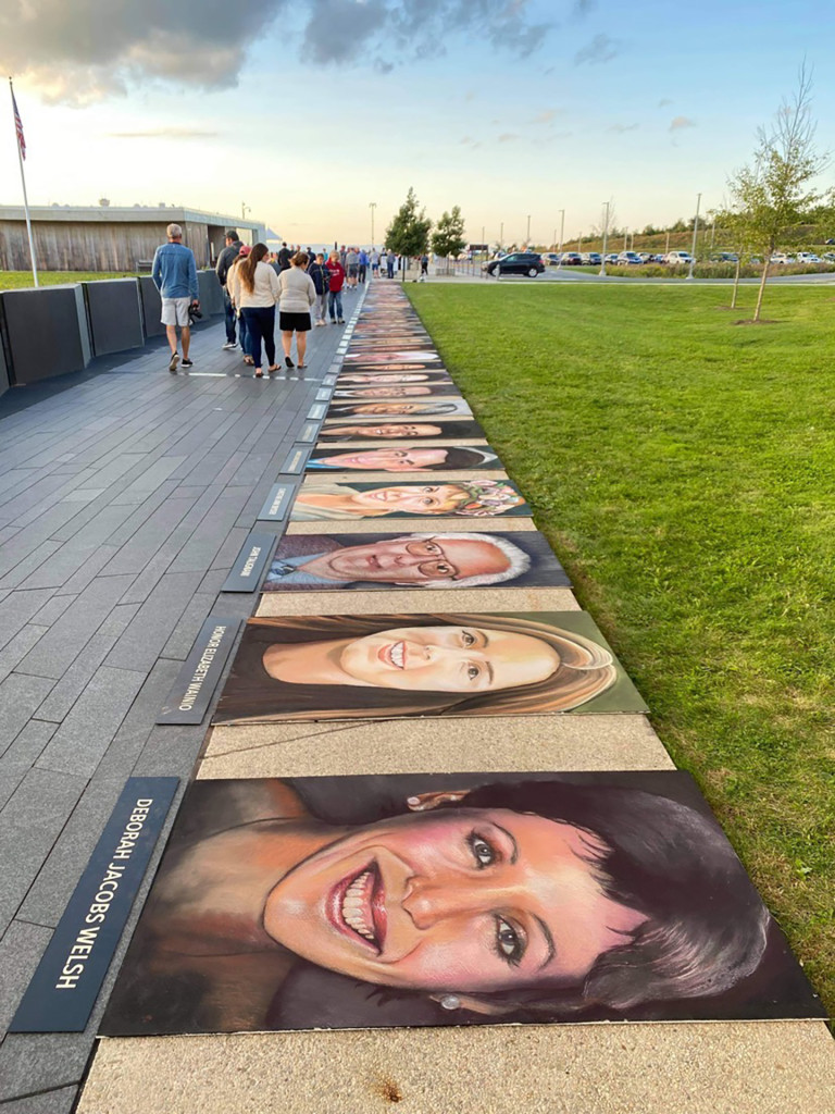 Row of chalk memorial portraits of the Flight 93 passengers and crew lining the memorial walkway