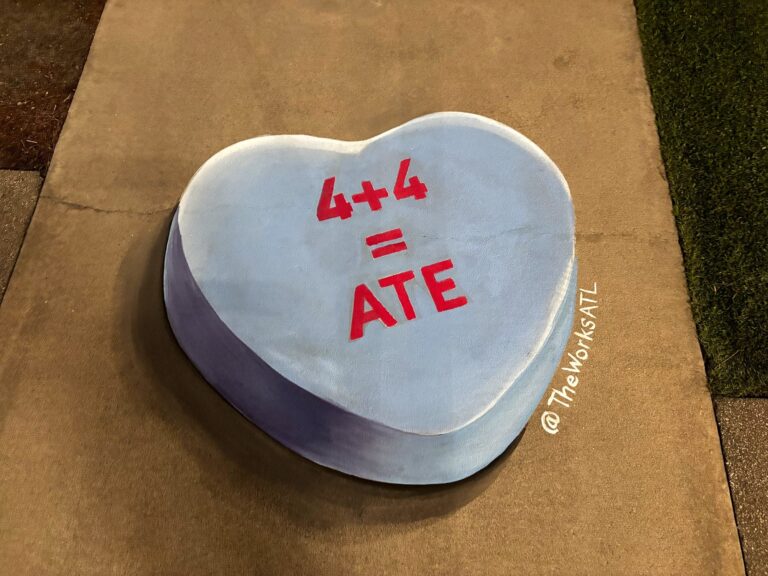 3D chalk blue candy heart reading 4 + 4 = Ate on a sidewalk at night