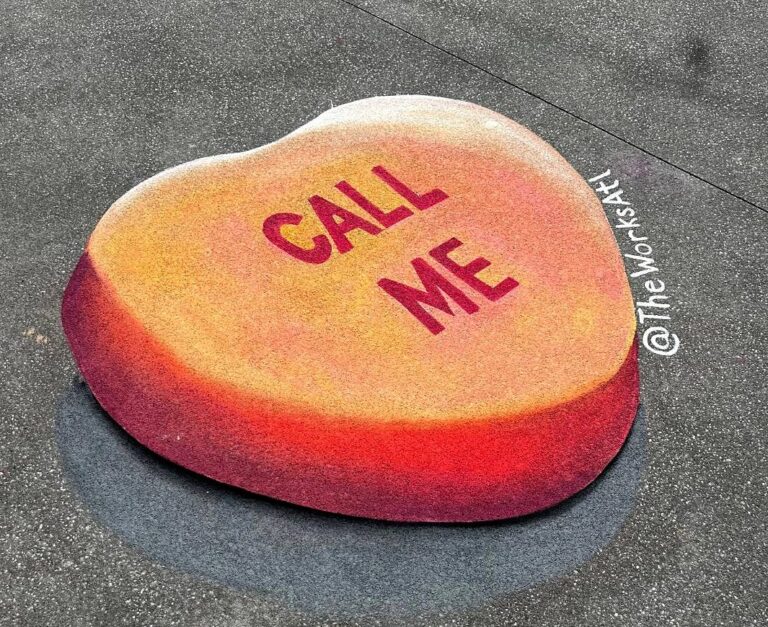 3D chalk candy heart in orange and red reading Call Me on the pavement