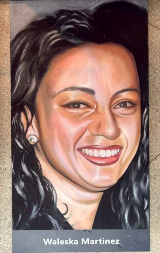 Jessi's finished chalk portrait of Flight 93 passenger Waleska Martinez, smiling, with dark curly hair and pearl earrings, above her name
