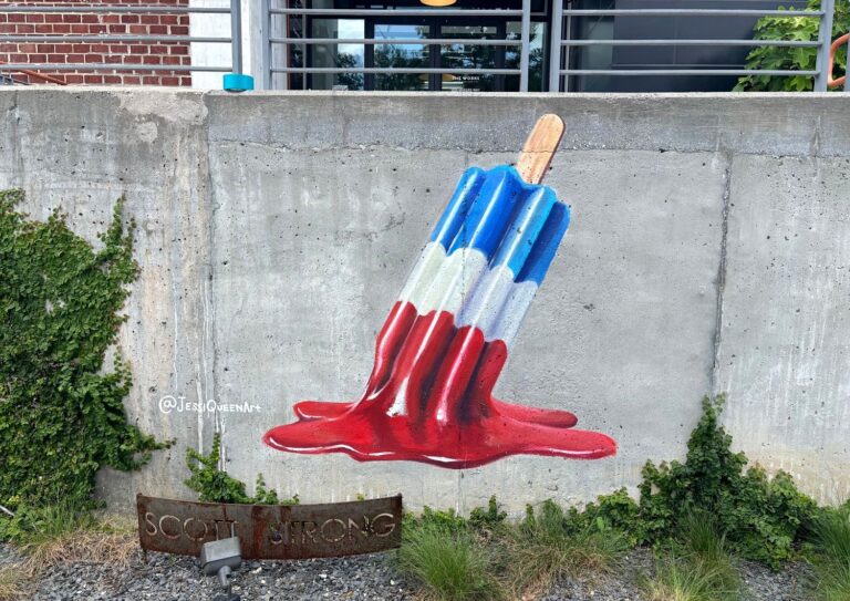 Painted mural of a melting red, white and blue rocket popsicle on a concrete wall at The Works