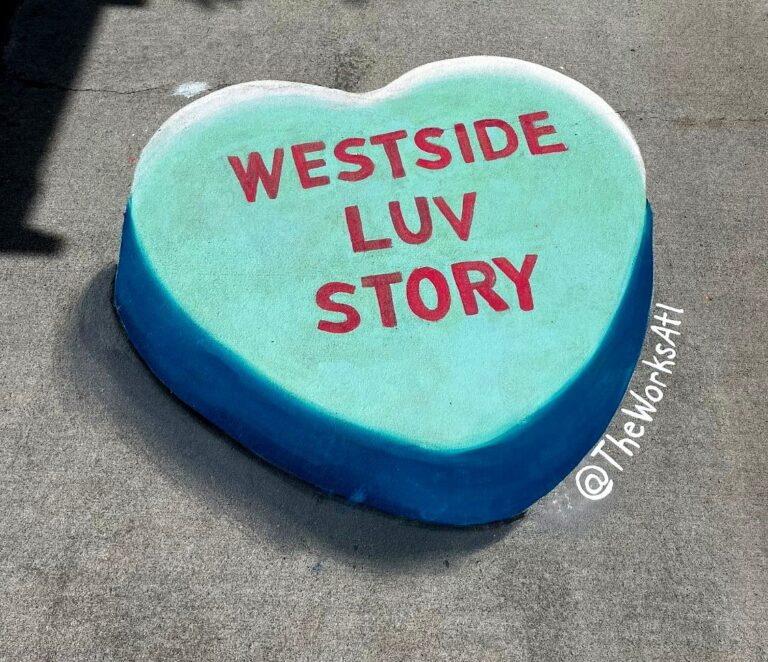 3D chalk mint and teal candy heart reading Westside Luv Story on a sidewalk